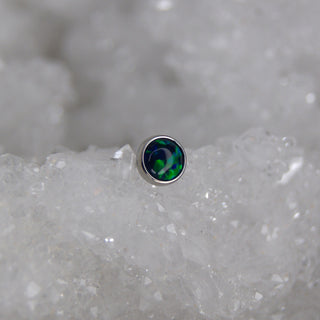 Small round opal stone on a gray mineral background junipurr jewellery threadless piercing jewelry push fit blue green peacock opal